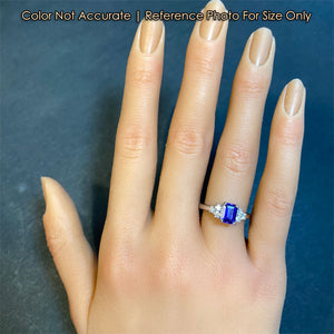 emerald cut tanzanite ring in platinum size to hand