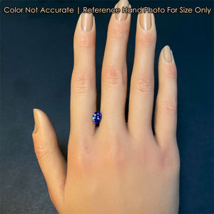 tanzanite gemstone on hand violet blue color