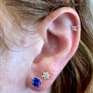 round brilliant tanzanite stud earrings on ear
