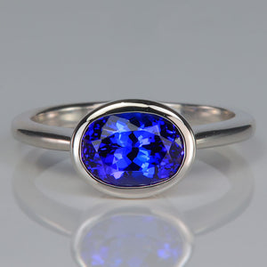 oval cut tanzanite gemstone is bezel set platinum ring