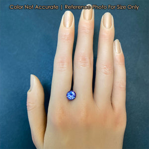tanzanite gemstone on hand for size