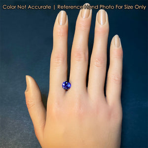 blue violet tanzanite gemston on hand