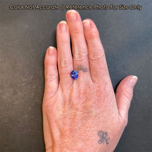 oval cut tanzanite gemstone on hand
