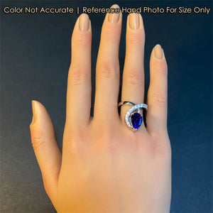 white gold tanzanite and diamond ring on hand size reference