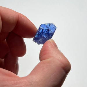 blue tanzanite crystal in hand
