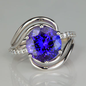 round brilliant tanzanite ring with diamonds in white gold