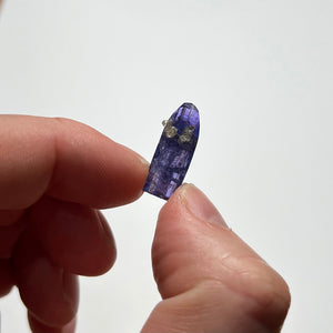 raw tanzanite in hand