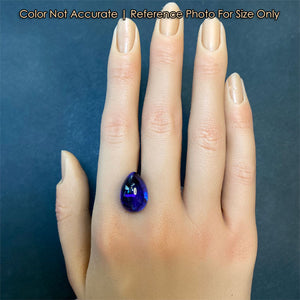 tanzanite blue violet cabochon gem on hand