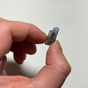 raw tanzanite crystal in hand