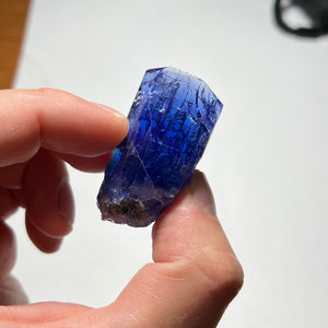 zoisite raw crystal in hand
