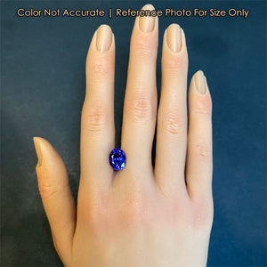 oval cut tanzanite gem on hand