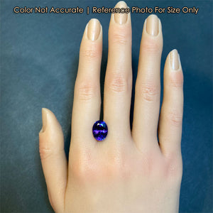 oval cut tanzanite gem on hand