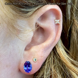 white gold oval tanzanite earrings on ear