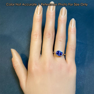 tanzanite gemstone ring in platinum on hand