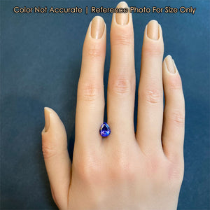 tanzanite pear shape gem on hand