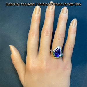 tanzanite ring with diamond accents on hand size reference