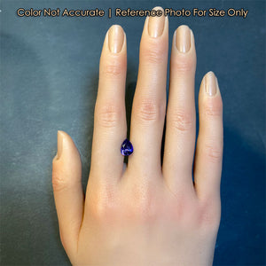 blue violet pear shape tanzanite on hand