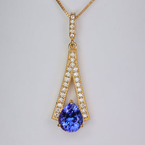 pear shape brilliant tanzanite gemstone in yellow gold pendant with diamonds