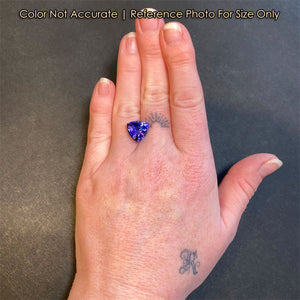 tanzanite gemstone on hand trilliant cut