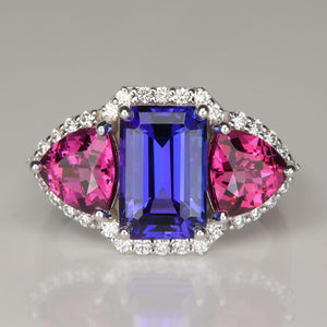 emerald cut tanzanite gemstone ring with umbalite garnets and diamonds in white gold