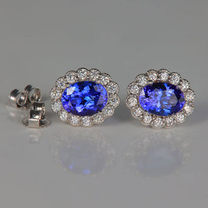 white gold tanzanite and diamond halo earrings