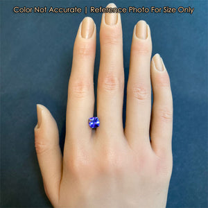 square cushion tanzanite gem on hand
