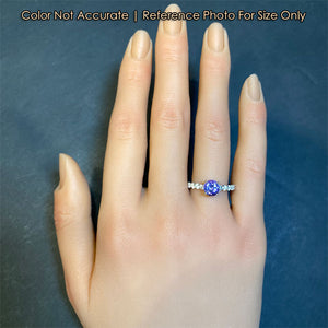 white gold tanzanite and diamond ring on hand