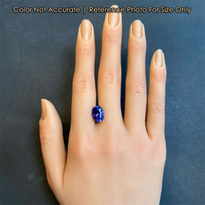 blue violet tanzanite gemstone on hand