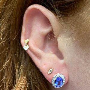 white gold and oval tanzanite earrings with diamond halo