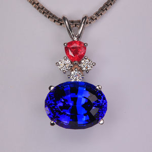 tanzanite gemstone pendant with diamonds and ruby in white gold