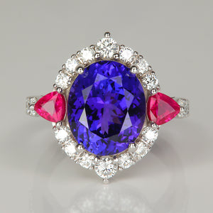 Oval cut tanzanite gemstone ring with trilliant cut ruby accents and diamonds in white gold