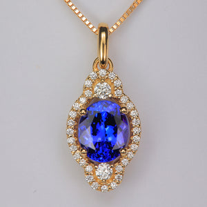 oval tanzanite gemstone in yellow gold pendant with diamonds