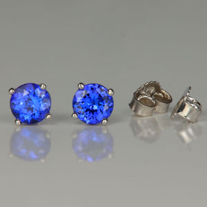 white gold mostly blue tanzanite round brilliant cut stud earrings