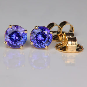 blue violet tanzanite gemstone stud earrings in yellow gold