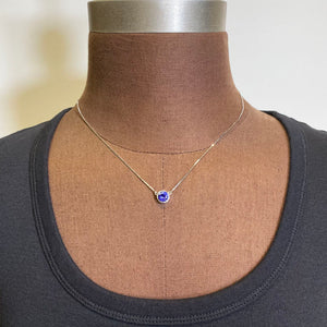round bezel set tanzanite white gold pendant