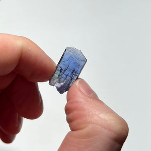 natural color tanzanite crystal in hand