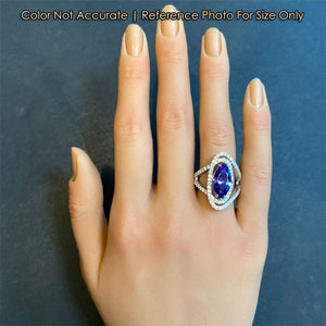 platinum and tanzanite ring with diamonds on hand