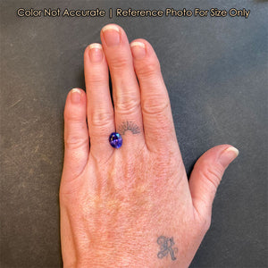 oval blue violet tanzanite on hand