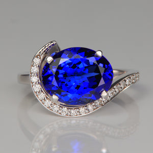 mostly blue oval cut tanzanite gemstone ring with diamonds in white gold
