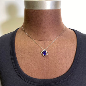 oval tanzanite white gold diamond swirl pendant