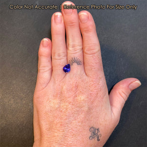violet blue pear shape tanzanite on hand
