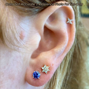 round tanzanite studs in white gold on ear