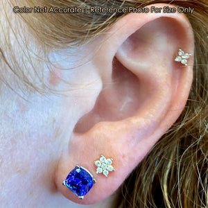 violet blue tanzanite gemstone earrings on ear