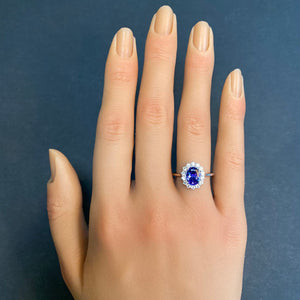 tanzanite and diamond halo ring on hand