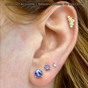 tanzanite stud earrings on ear .96ct