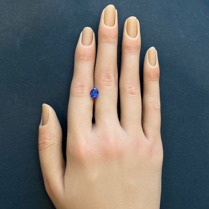 Oval 1ct tanzanite on hand blue
