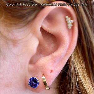 white gold tanzanite stud earrings on ear size 