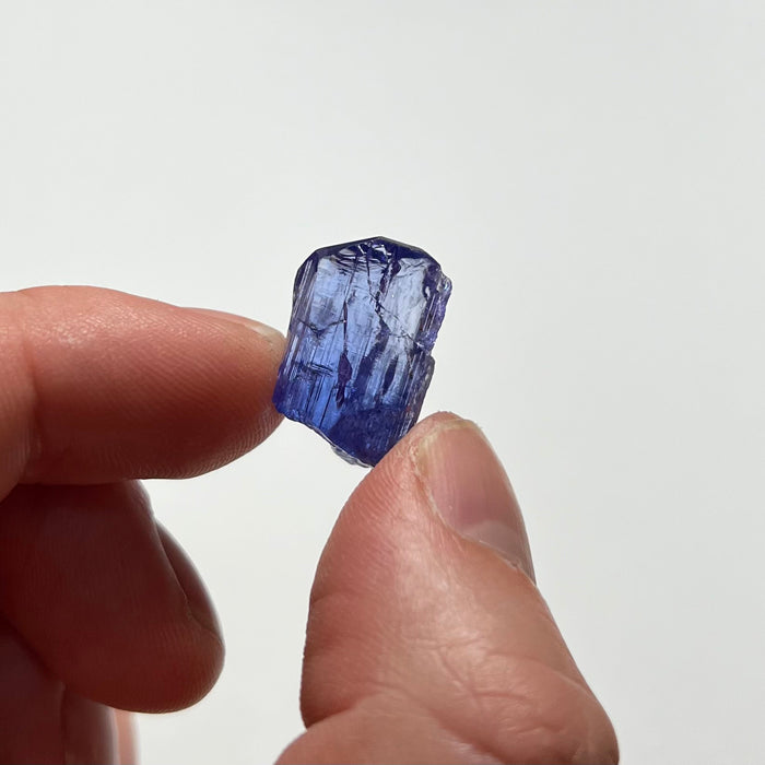 hand holding tanzanite crystal for size