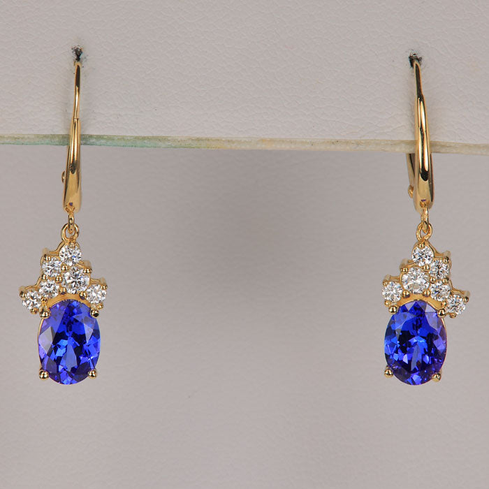 yellow gold drop earrings with oval cut mostly blue tanzanite gemstone and diamonds 