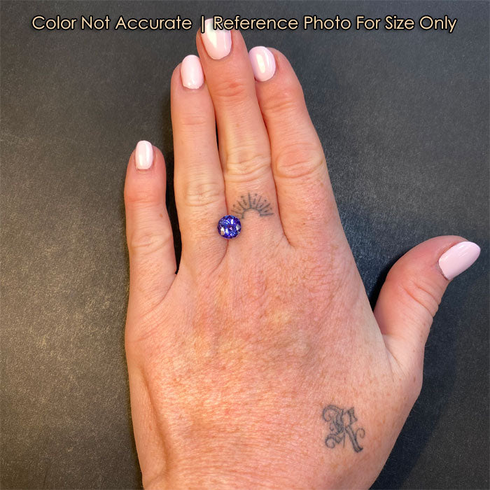 size of round tanzanite gemstone on hand 